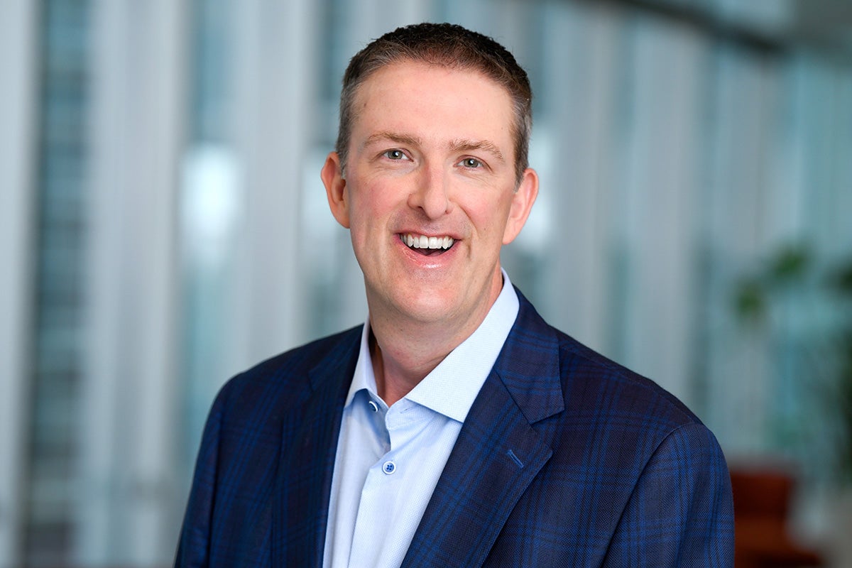 portrait of man in blue business suit and light blue collar shirt