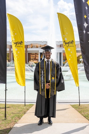 Latrell Sam-German wearing a rad cap and gown