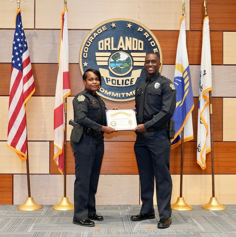 One police officer presenting another with an award