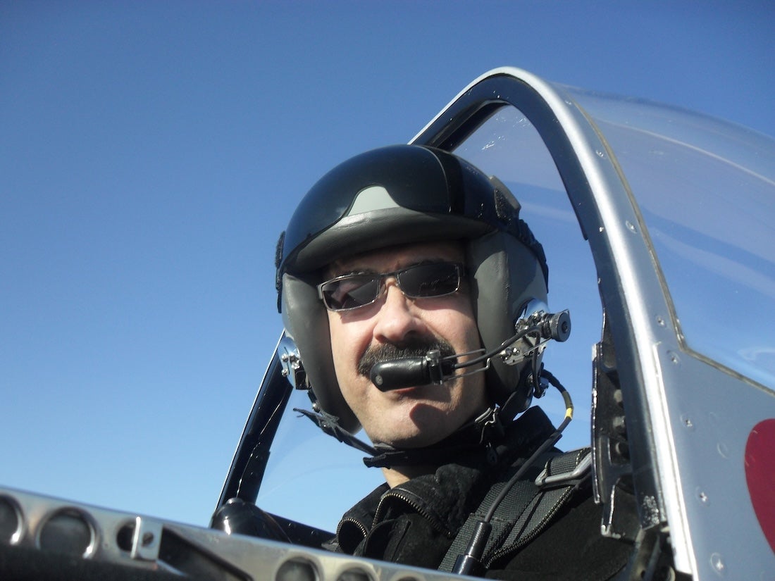 Melchor Antuñano flying in a biplane