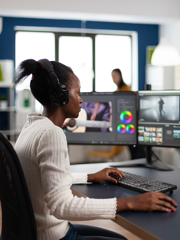 Person working in front of a computer editing video.