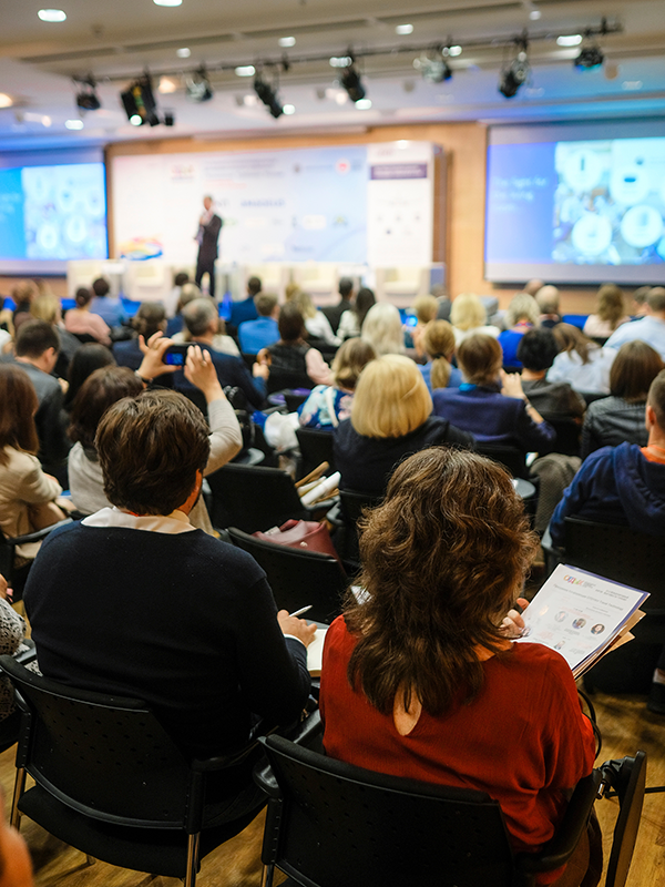 individuals in a conference center viewing a presentation