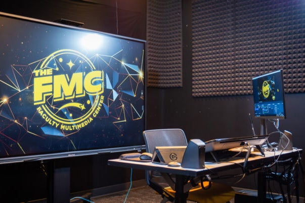 Faculty Multimedia Center recording studio bay with monitor, mics, and lights