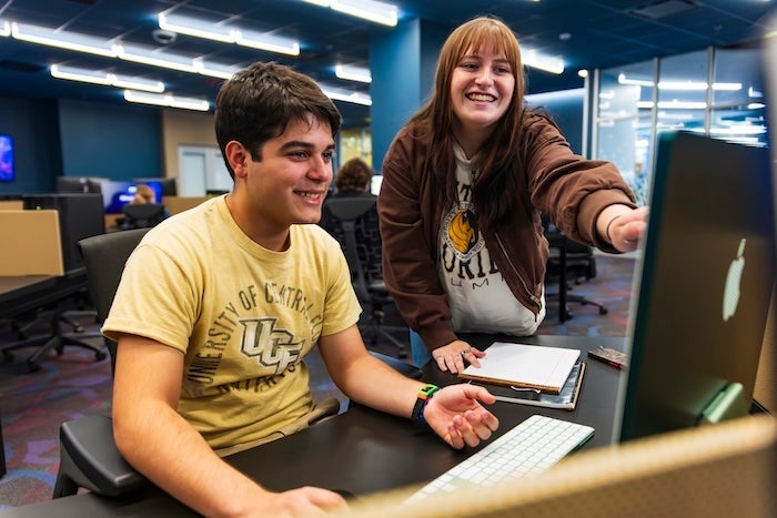 two students working on a digital assignment