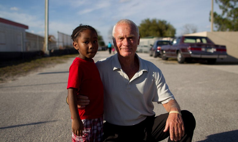 Harris Rosen with posing with a young child