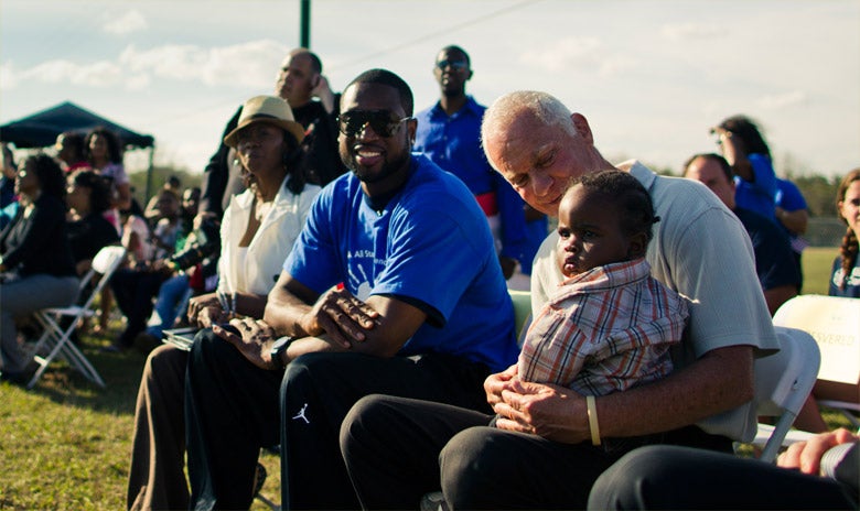 Image of Dwayne Wayde sitting with Harris Rosen