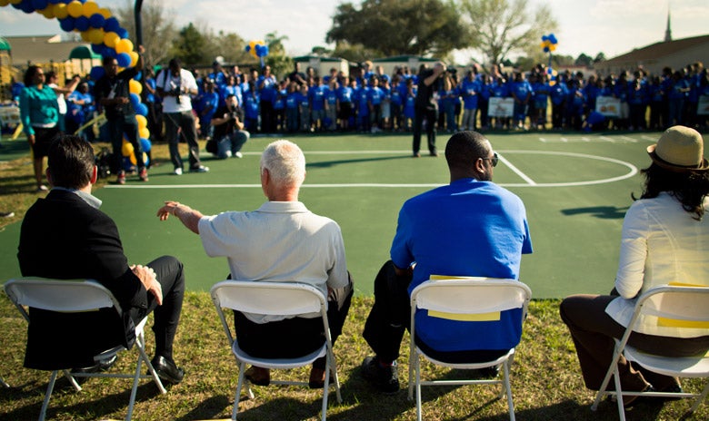 Image of Dwayne Wayde sitting with Harris Rosen