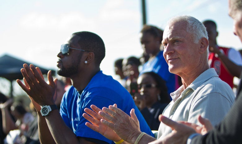 Image of Dwayne Wayde sitting with Harris Rosen