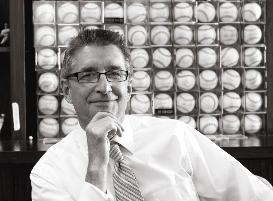 Dr. Paul Jarley, College of Business Administration dean, displays his baseball collection in his office.