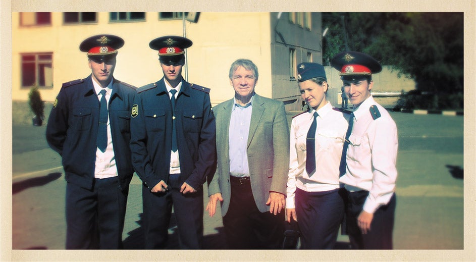 Reynolds (center) stands alongside Russian academy cadets after they receive their five-year university degrees and second lieutenant commissions. Ivan Zamylin, '11, (far left) later earned his M.B.A. at UCF.