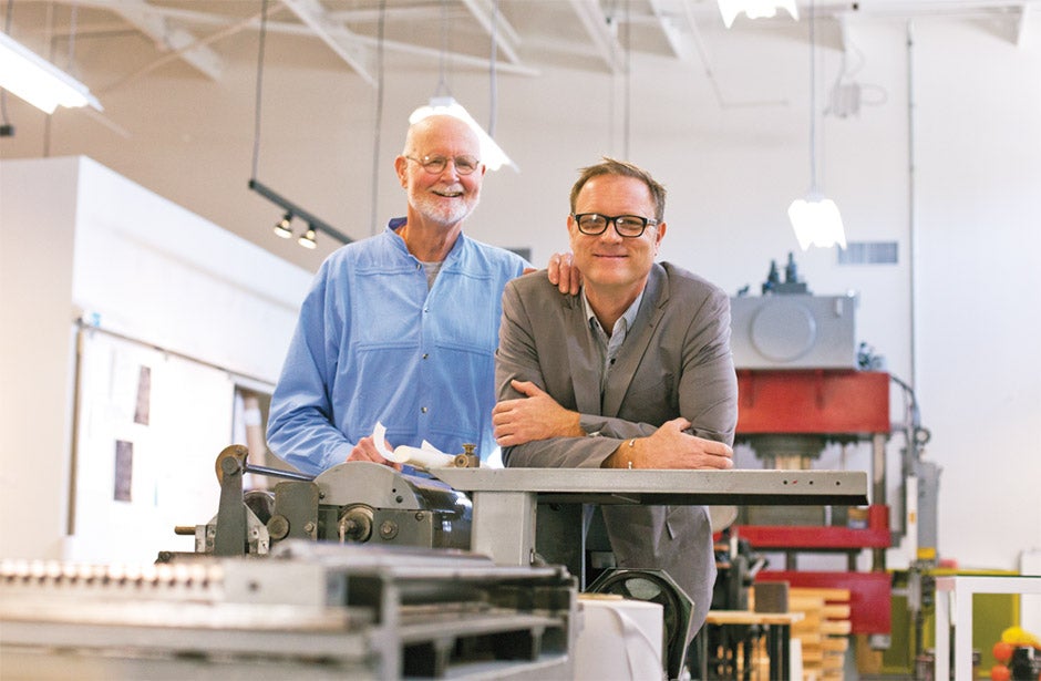 Steve Lotz and son Theo standing in classroom.