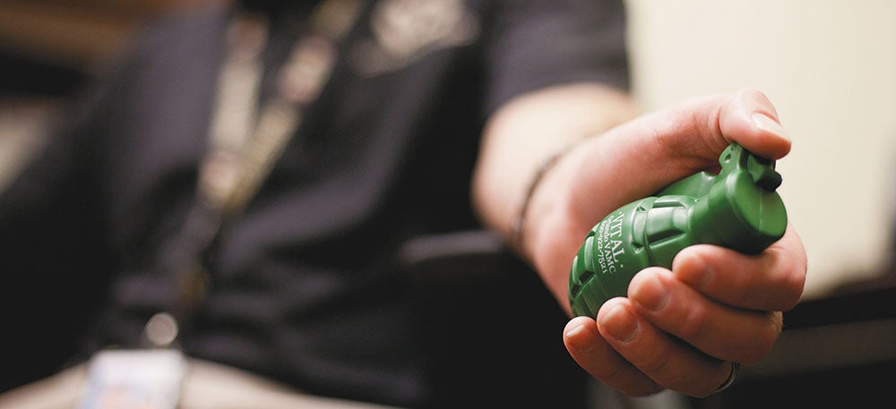 U.S. Department of Veterans Affairs psychologist Bryan Batien hands out stress relief squeeze toys shaped like hand grenades at the Veterans Academic Resource Center.