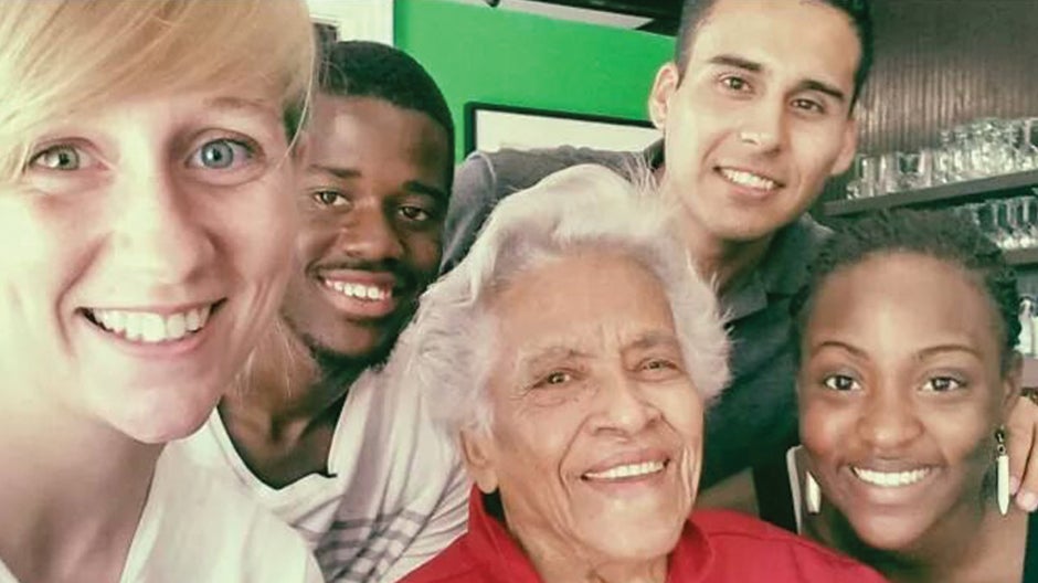 Four people smiling with Leah Chase, Dooky Chase's Restaurant owner/chef
