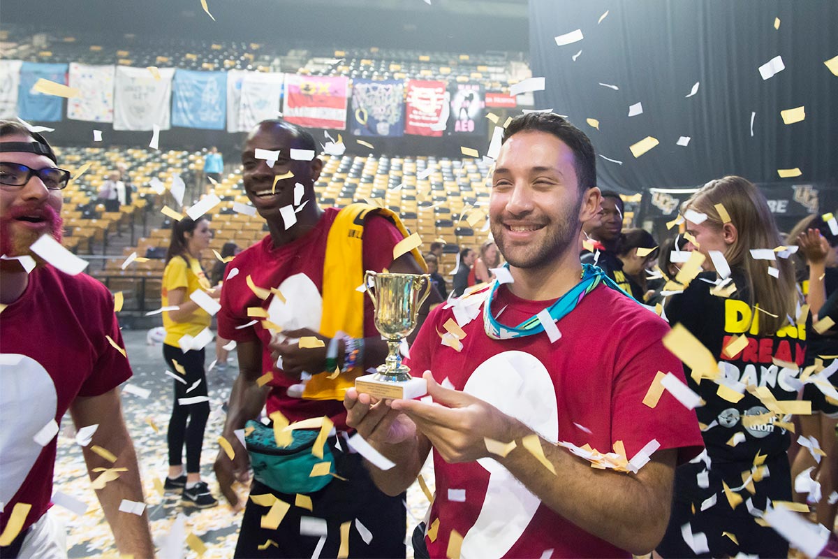 Volunteer with Trophy in Confetti