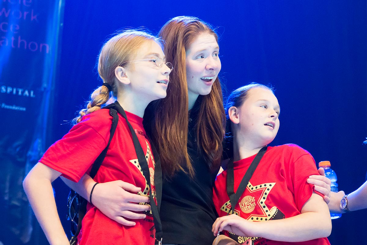 Kids on Stage with Volunteer