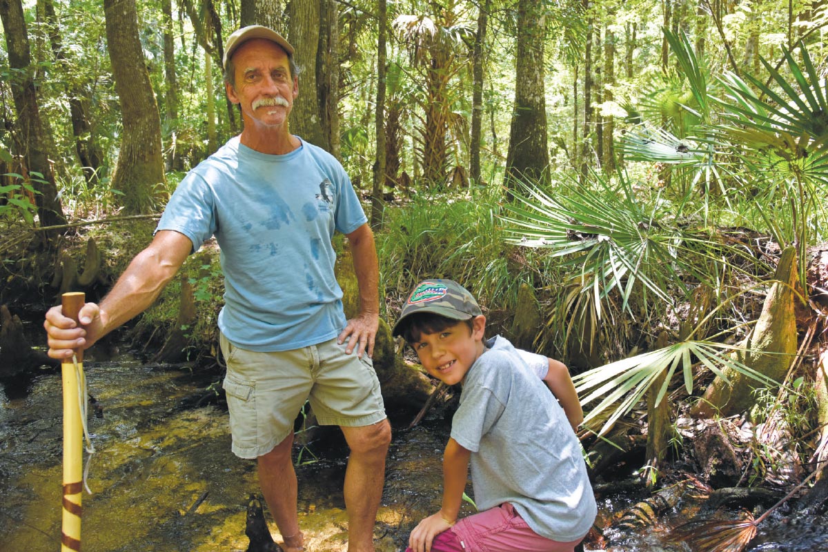 Noss and his grandson Kai explore Mills Creek near Chuluota, Florida.