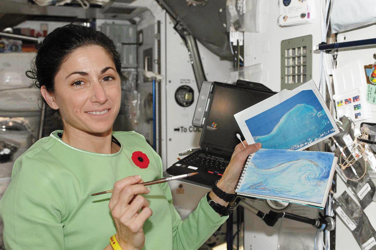 Nicole Stott holding paintings Nicole Stott holding paintings