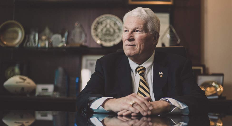 Dr. John C. Hitt, in his office sitting at his desk