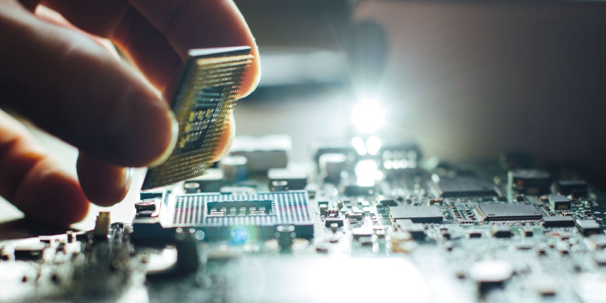 Hand placing micro processor onto a motherboard Hand placing micro processor onto a motherboard