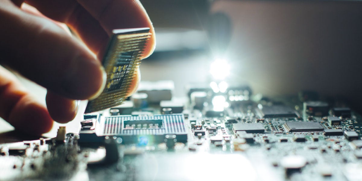 Hand placing micro processor onto a motherboard