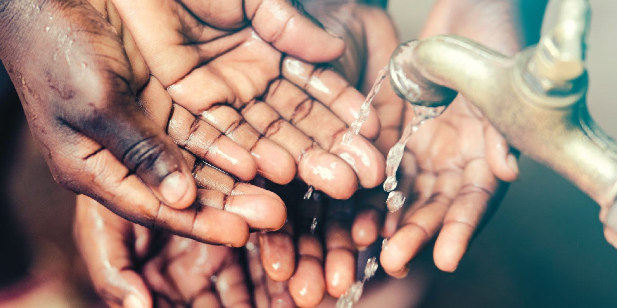 Hands under a spigot