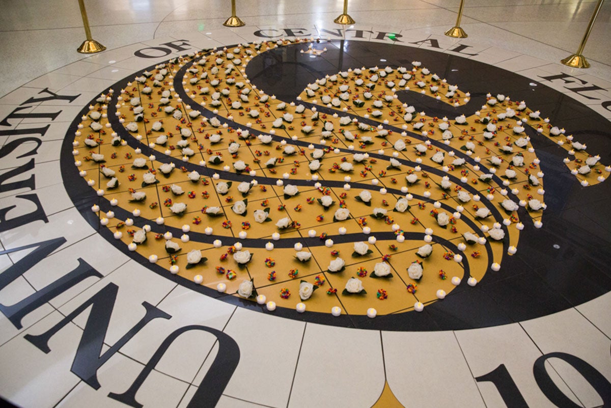 The giant Pegasus seal on the floor of the Student Union was filled in with white tea candles and tiny rainbow roses. The giant Pegasus seal on the floor of the Student Union was filled in with white tea candles and tiny rainbow roses.