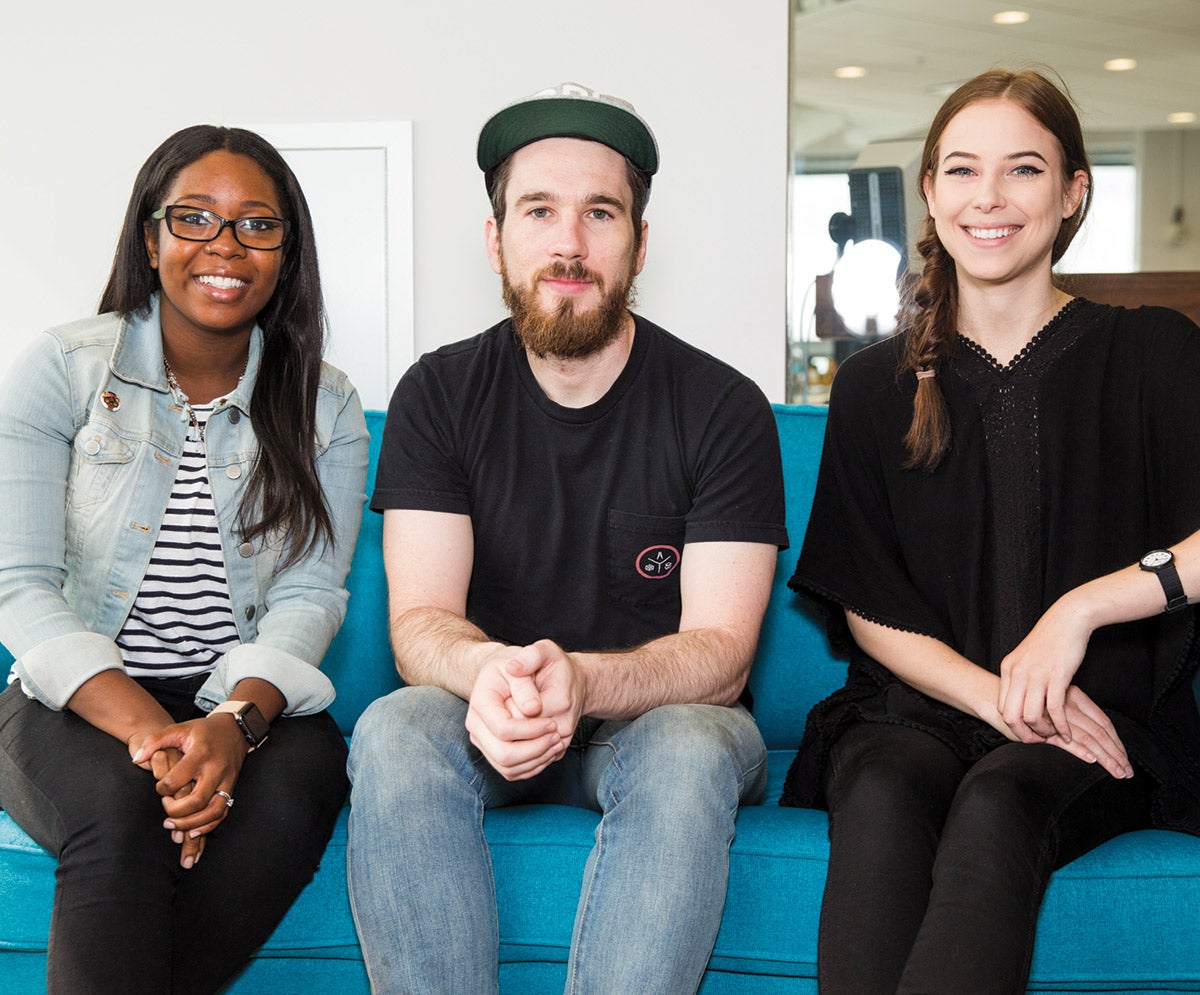 Ayana Campbell, Drew Powers, and Morgan Walker sit on a blue couch.