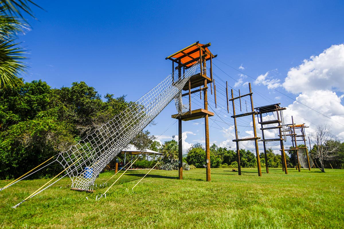 An entire high-elements course shows the four platforms with various wires and a rope net.