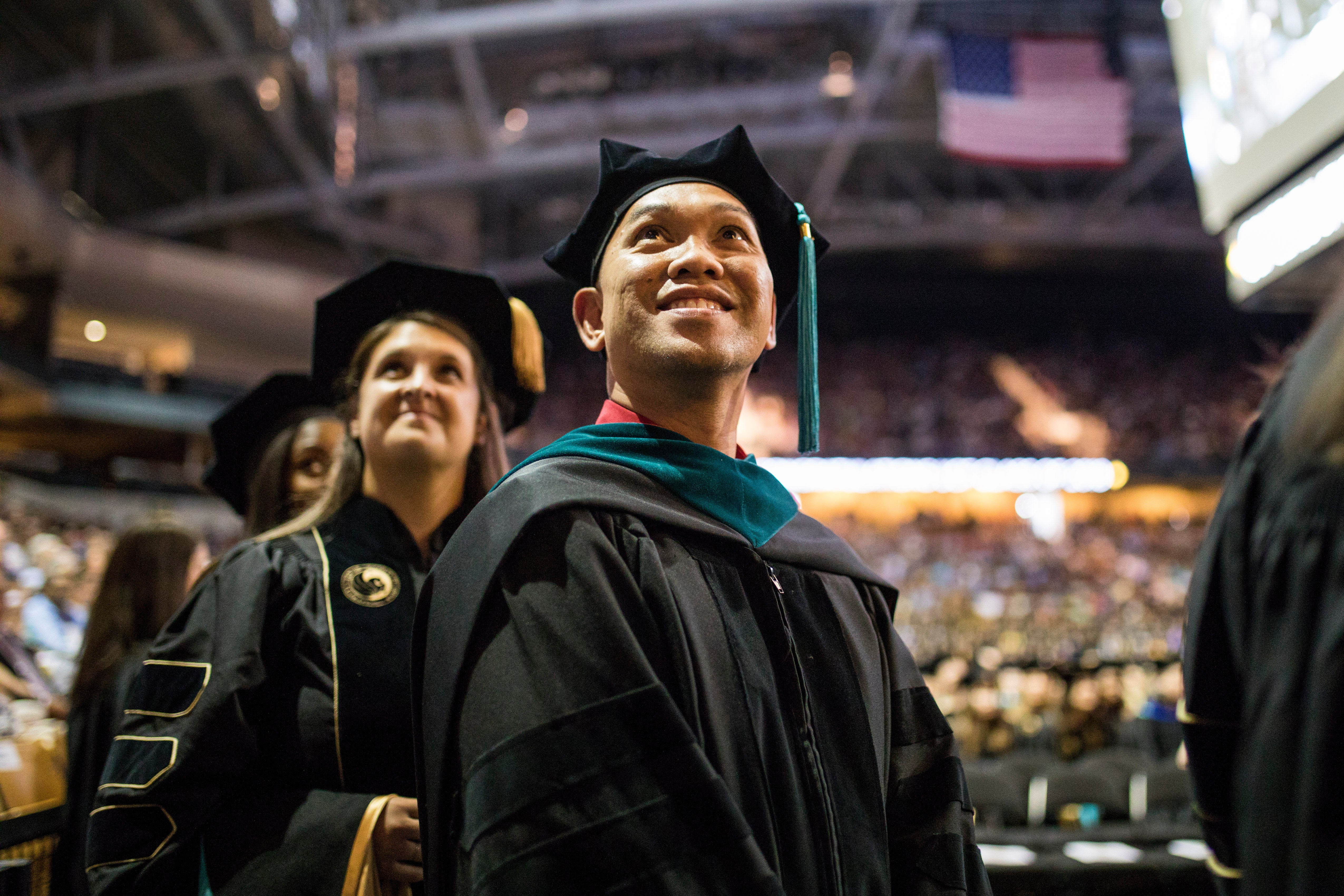 A male student looks up in awe at the crowded CFE Arena. A male student looks up in awe at the crowded CFE Arena.