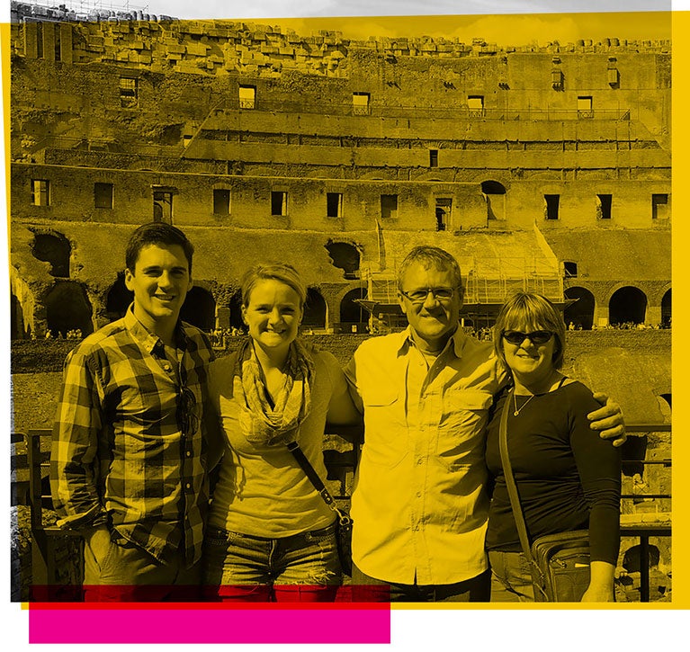 Dale Whittaker posing with his family in front of a landmark in Rome