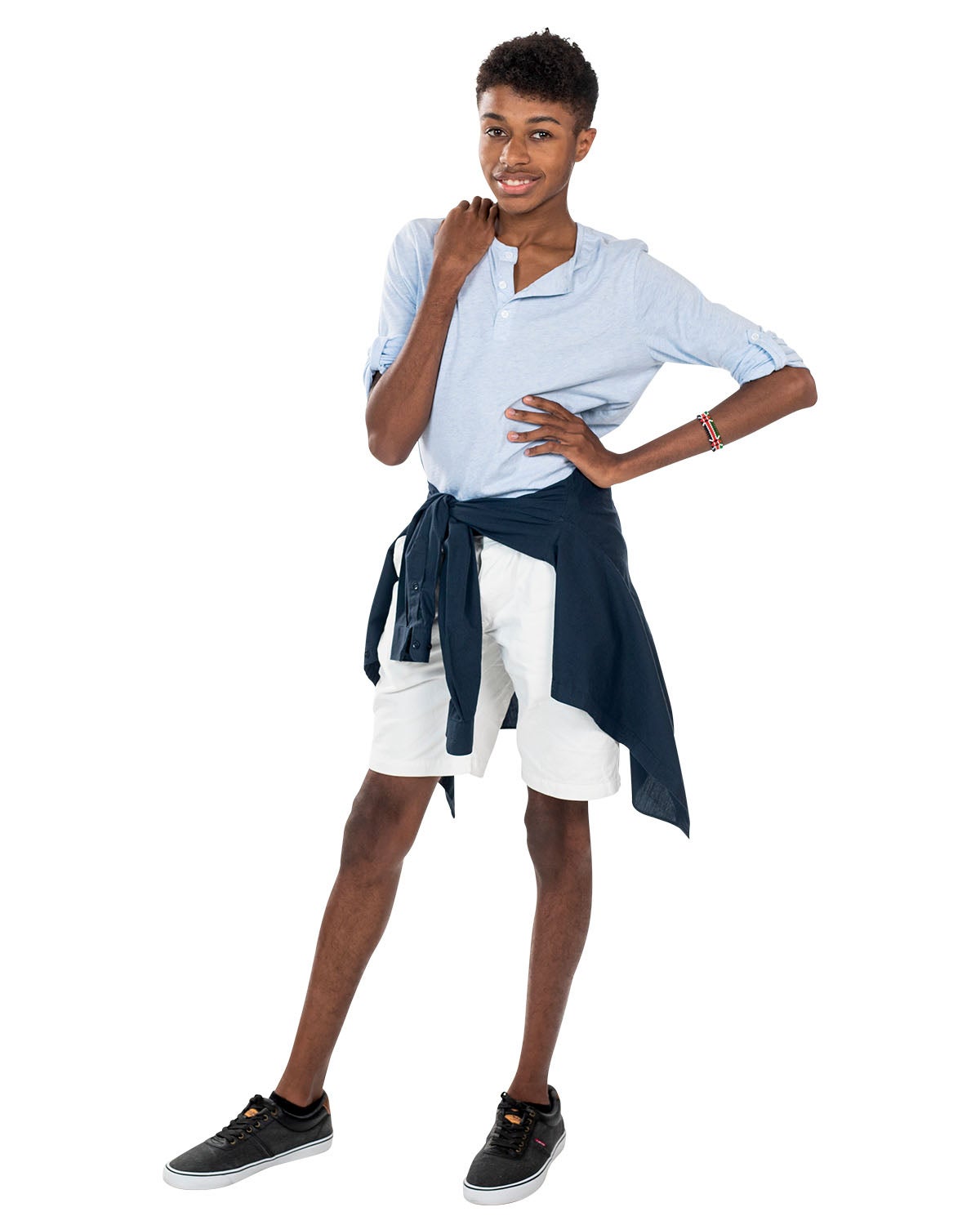A man in a light blue shirt and white shorts poses with his hand on his hip. A man in a light blue shirt and white shorts poses with his hand on his hip.