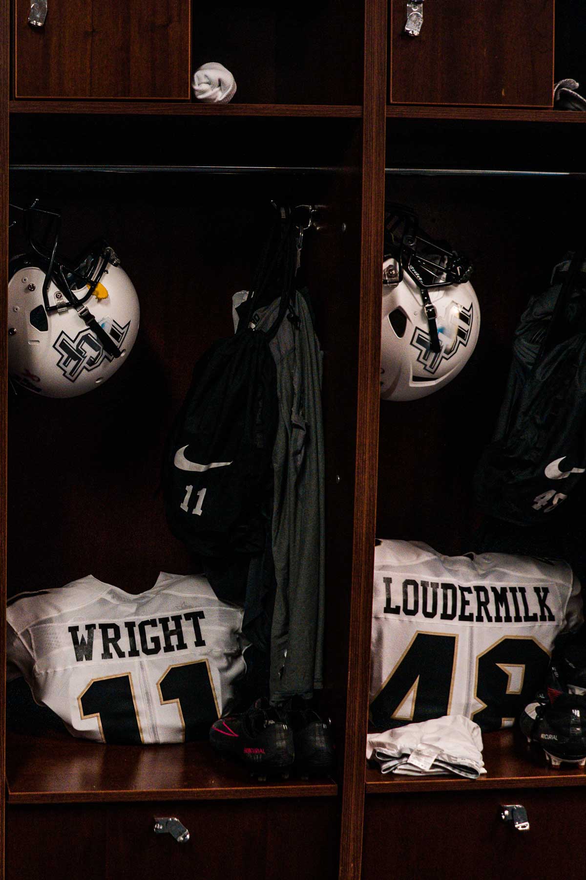 two lockers with white jersey and white helmets