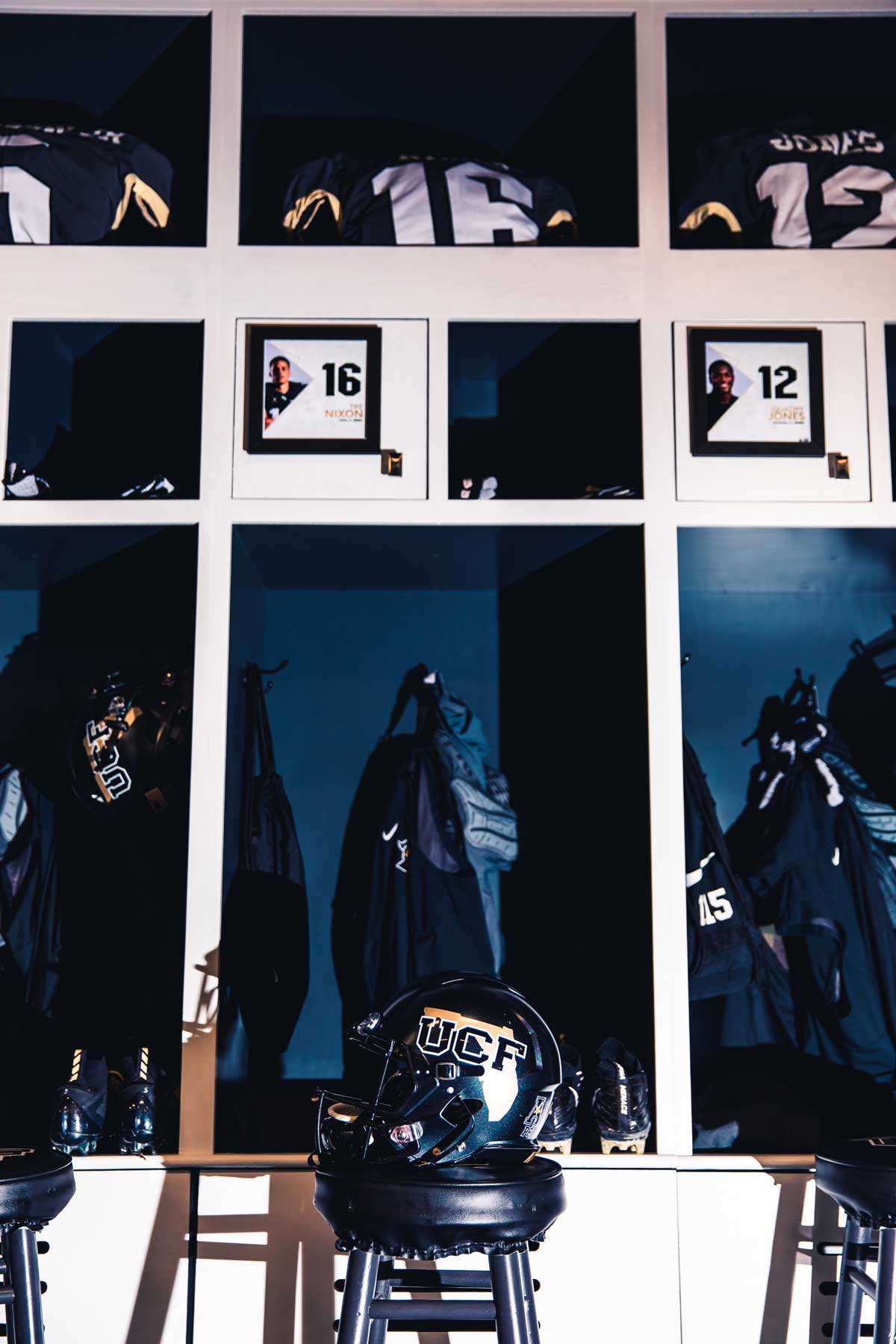 rows of three lockers with a black UCF helmet with the outline of the state of Florida on the side
