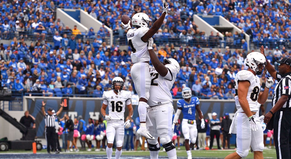 ucf offensive lineman jordan johnson celebrates with ucf  running back taj mcgowan during memphis game