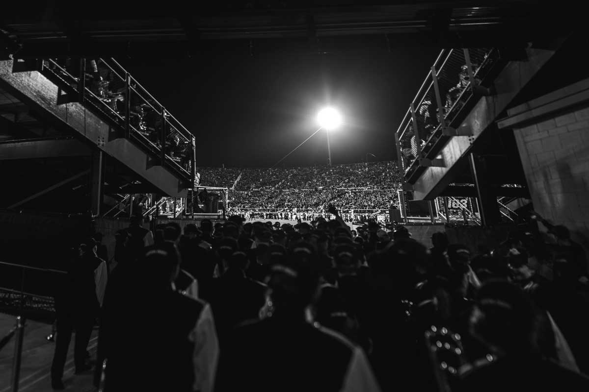 black and white of band entering football field