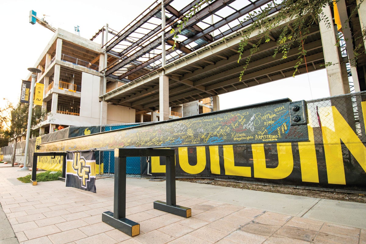 A steel beam outside the UCF Downtown campus is covered with signatures.