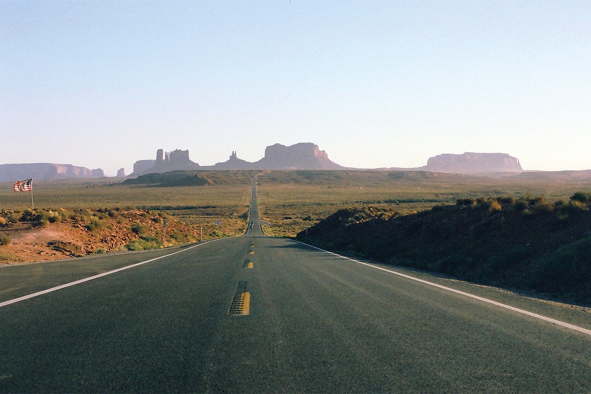 A road in front of buttes.