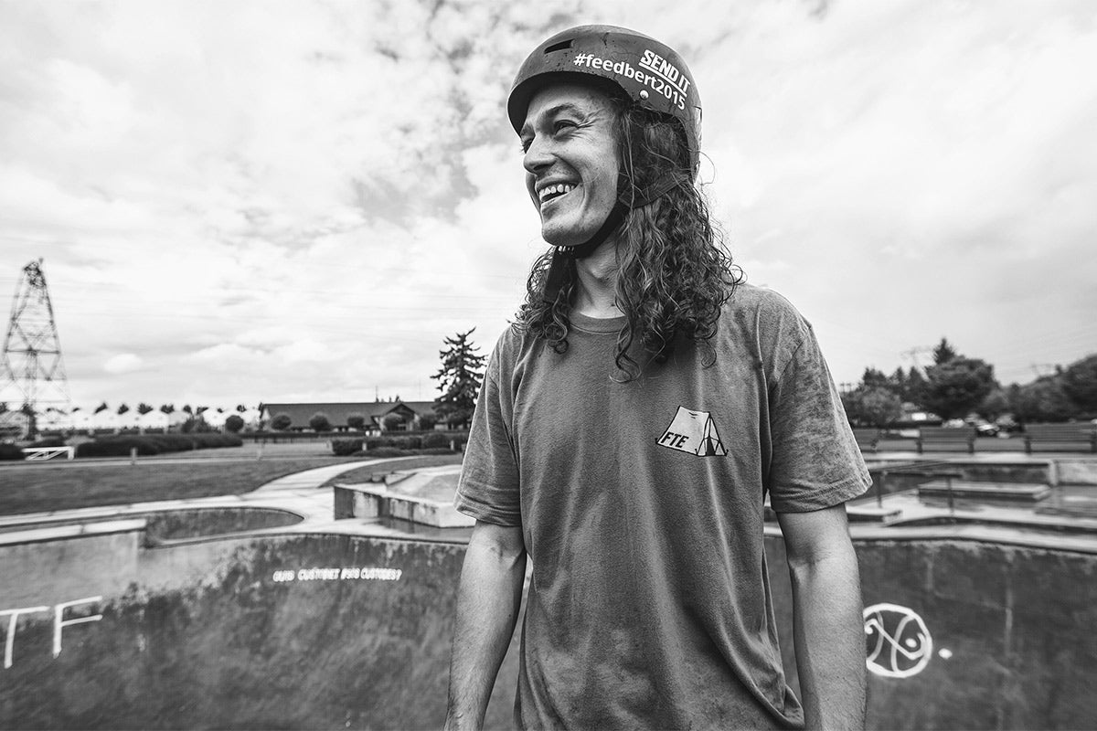 A black and white photo of a man wearing a helmet.