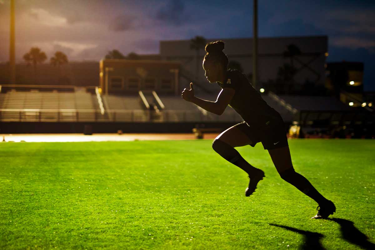 female soccer player takes off running on soccer field