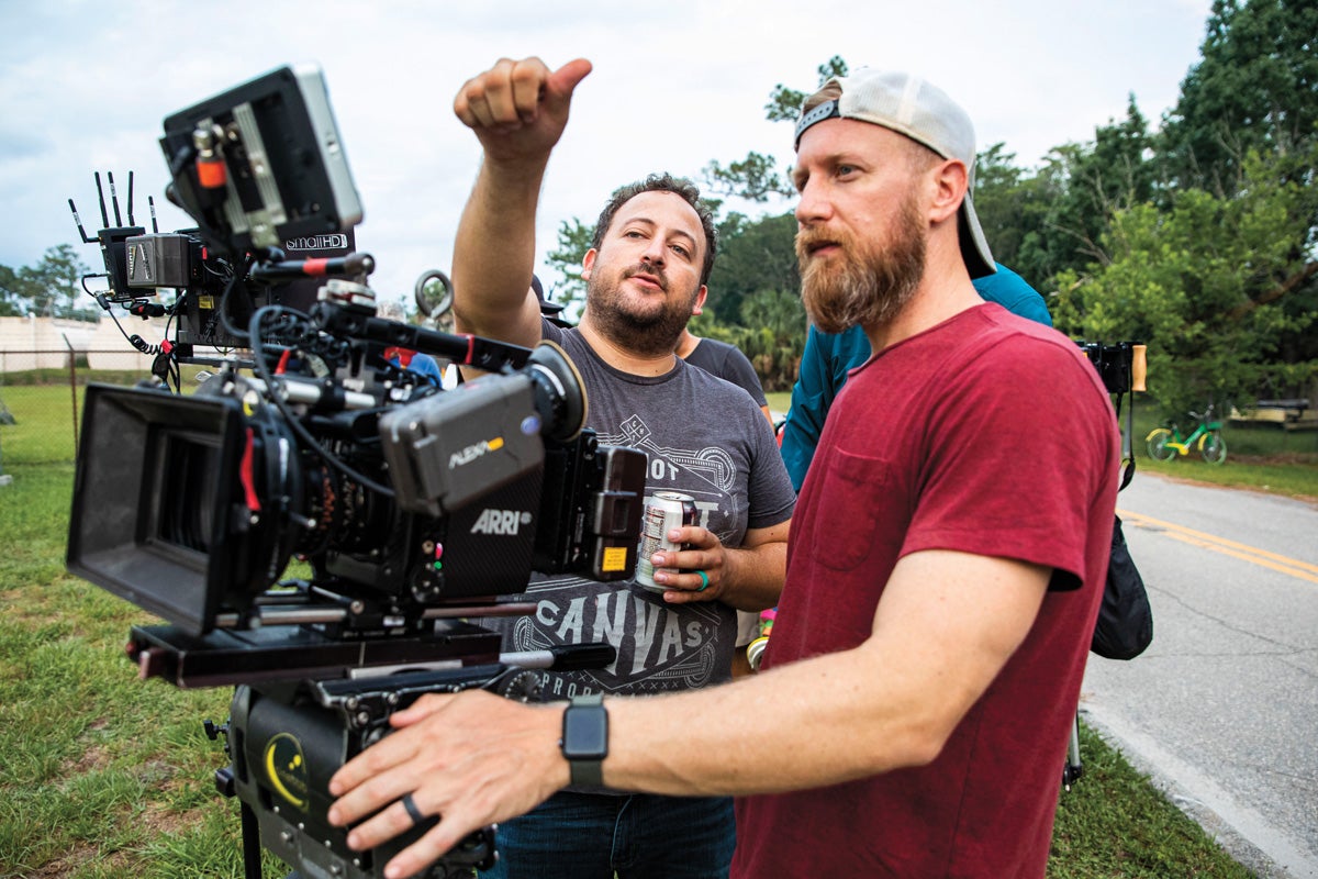 A man directs a cameraman.