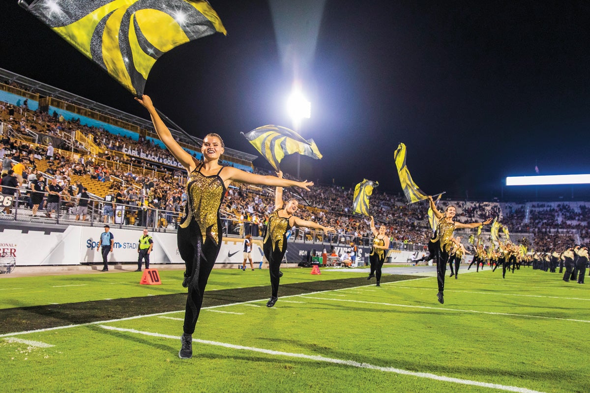 The color guard waves flags inside Spectrum Stadium.