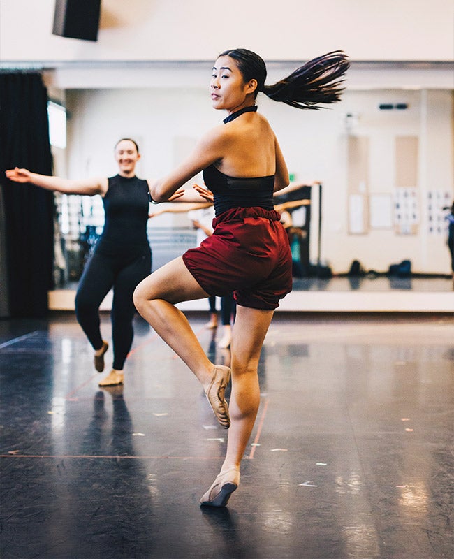 Dancer spins on one foot in studio