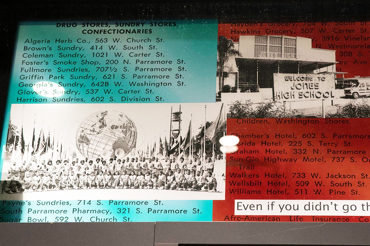 Stained glass showing picture of Jones High School and the marching band at the 1964 World's Fair.