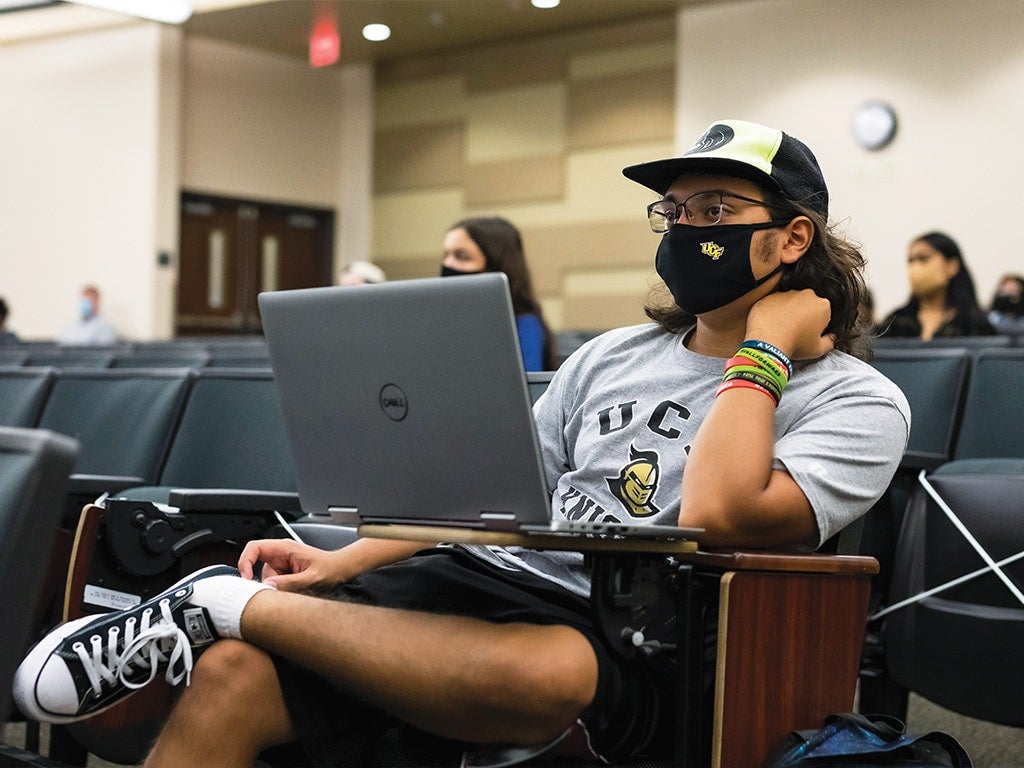 ucf student sitting in class with mask on