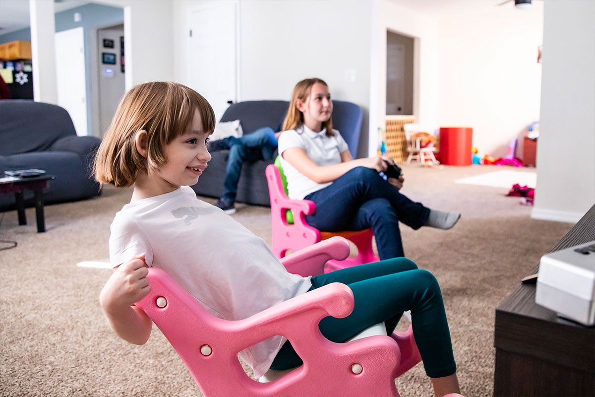 Ava Brown sitting with her sister