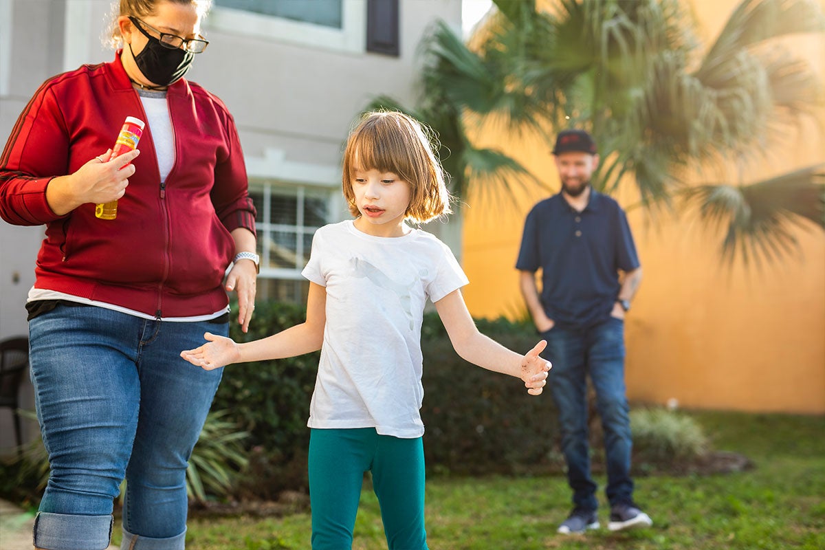 Ava Brown walking as family members watch