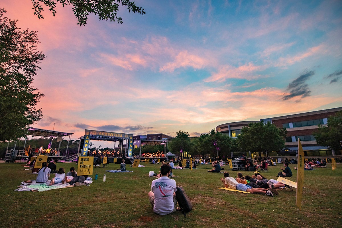 The sun sets as Knights sit on Memory Mall during a concert