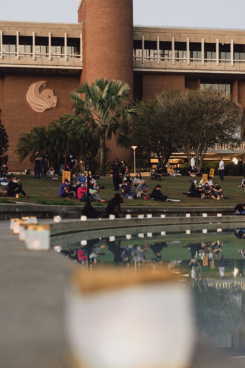 Knights sitting at the Reflecting Pond for a vigil.