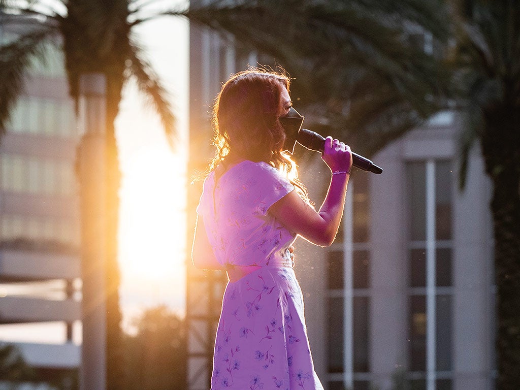 A woman singing into a mic