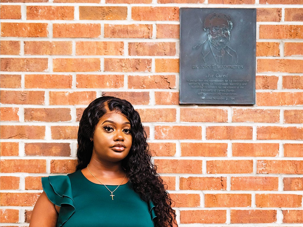 Derreasha Jones in front of the John T. Washington plaque Derreasha Jones in front of the John T. Washington plaque